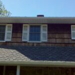 before construction photo showing old and rotten wood shingle on home