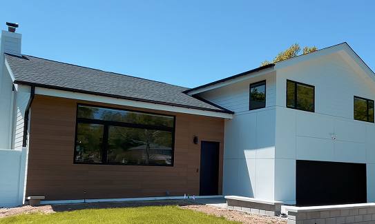 Modern home with wood-look Hardie panel and white lap siding