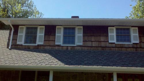before construction photo showing old and rotten wood shingle on home